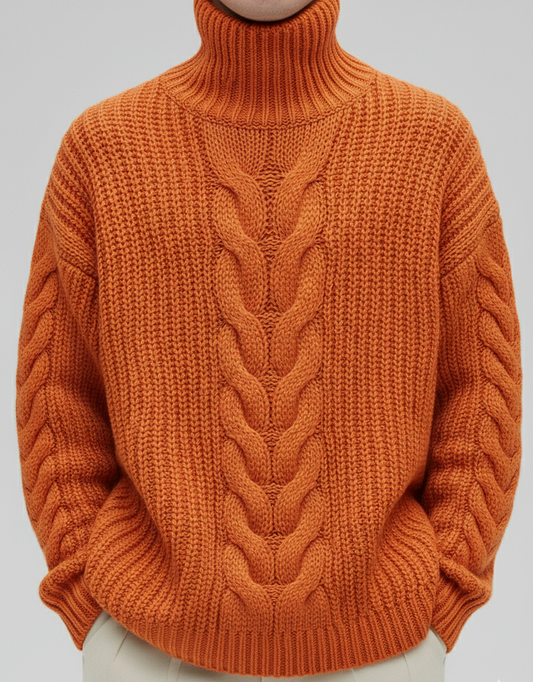 Orange cable knit sweater worn by a person on a plain background